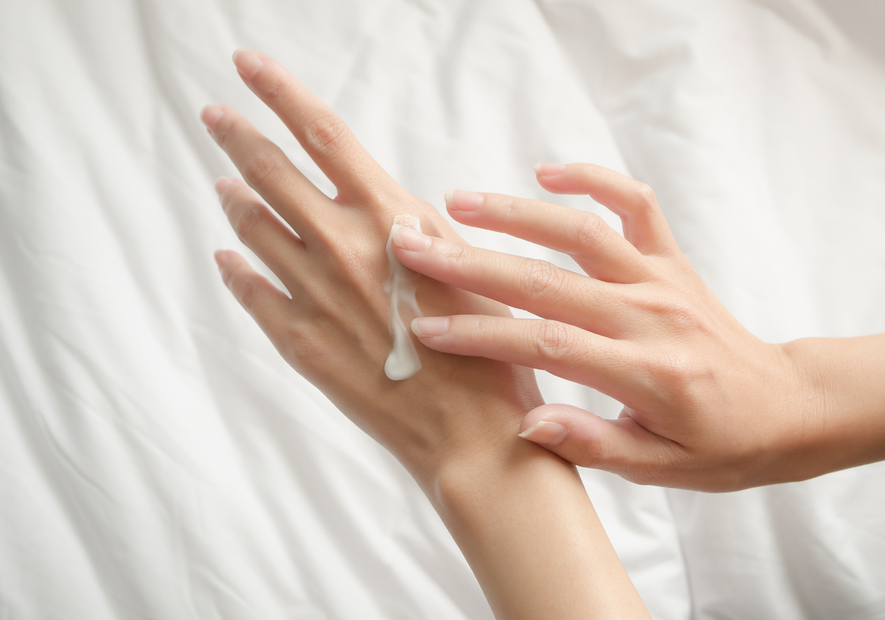 Beautiful woman hands with cream